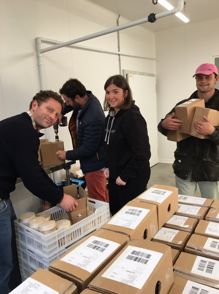 People packing cheese in boxes